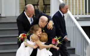 Jonathan Mintz and John Feinblatt, embracing their daughters Maeve and Georgia, in celebration of their marriage.  - photo: Reuters